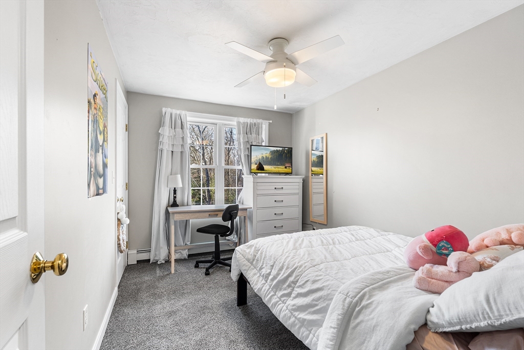 52 Deanville Road Attleboro, MA 02703 - Photo 17 of 30 a bedroom with a bed and a chandelier