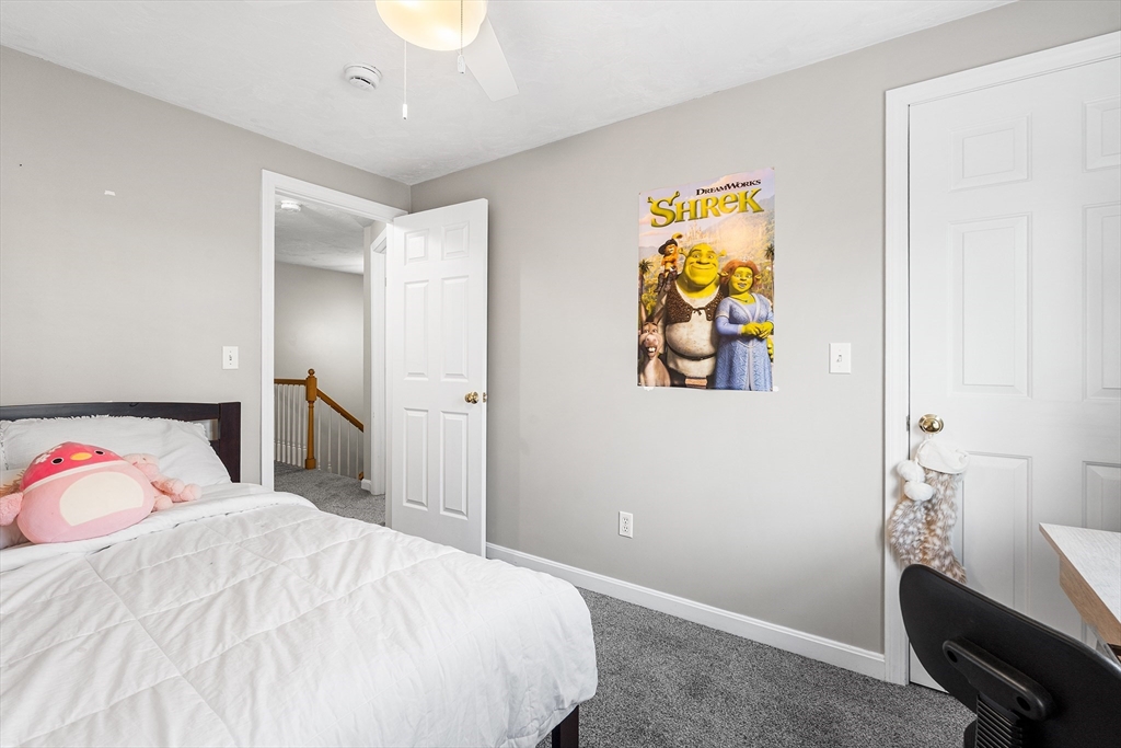 52 Deanville Road Attleboro, MA 02703 - Photo 18 of 30 a bedroom with a bed and a chandelier