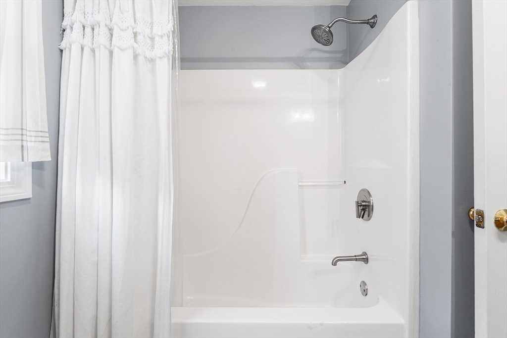 52 Deanville Road Attleboro, MA 02703 - Photo 20 of 30 a close up of a bathtub curtain