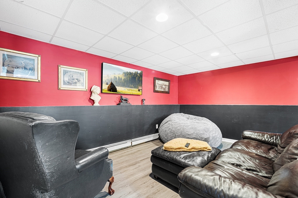 52 Deanville Road Attleboro, MA 02703 - Photo 22 of 30 a living room with furniture and a flat screen tv