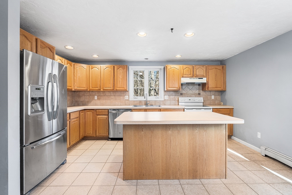 52 Deanville Road Attleboro, MA 02703 - Photo 8 of 30 a kitchen with stainless steel appliances granite countertop a sink stove and refrigerator