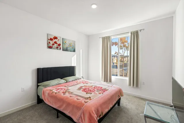 a bedroom with a bed and a wall painting