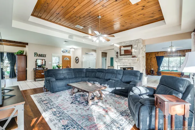 a living room with furniture a flat screen tv and a large window