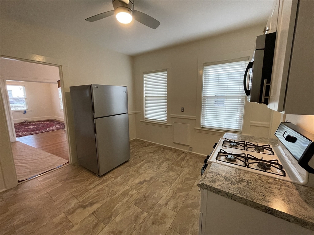 62 Ibbetson Street, Unit 3L Somerville, MA 02143 - Photo 12 of 20 a kitchen with a refrigerator and a stove top oven