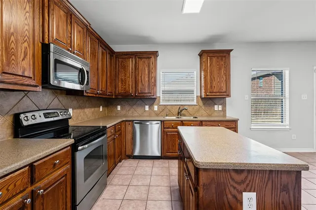 a kitchen with a stove a sink and a microwave