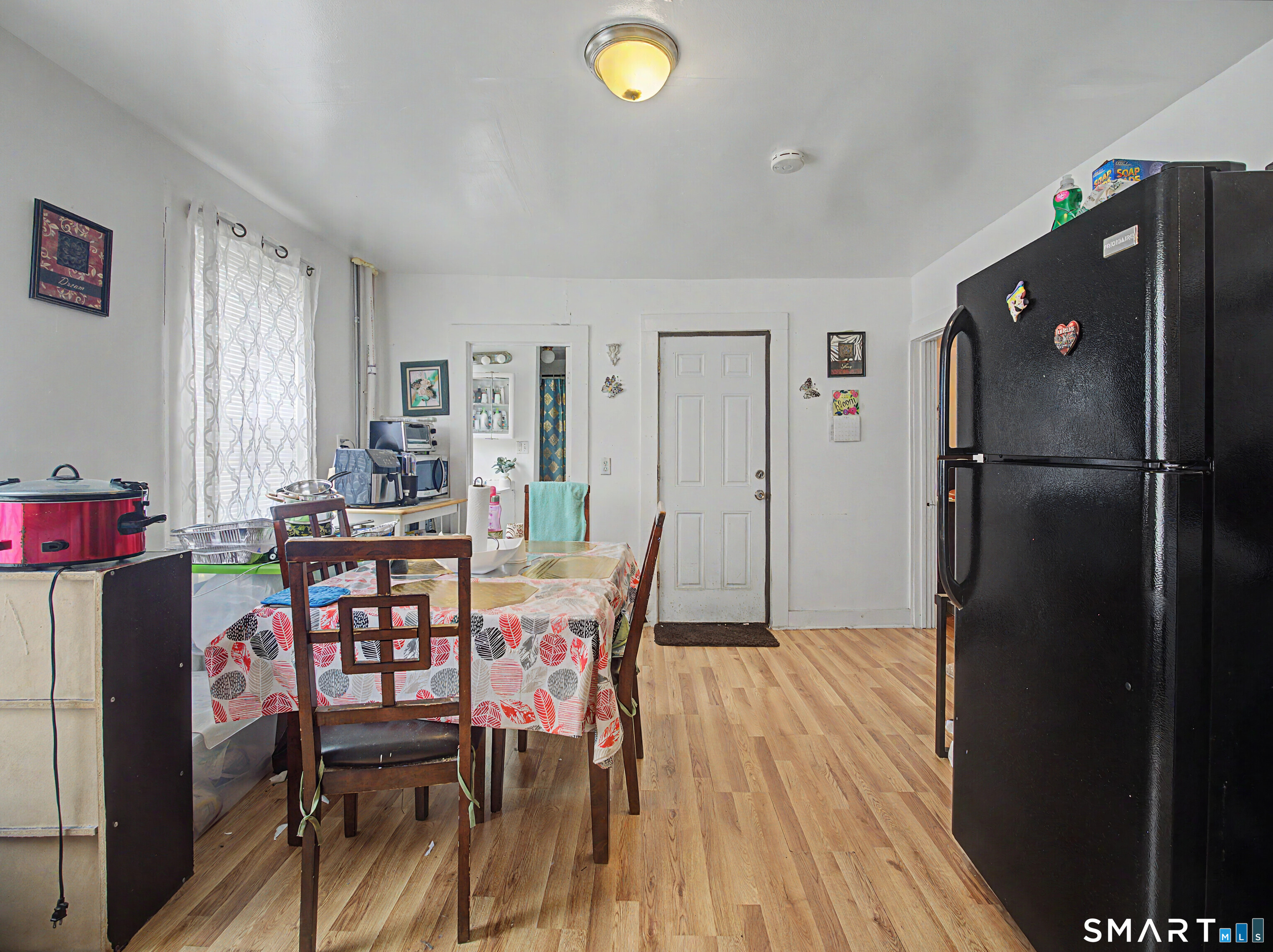 319 Carroll Avenue Bridgeport, CT 06607 - Photo 13 of 40 a kitchen with stainless steel appliances refrigerator dining table and chairs