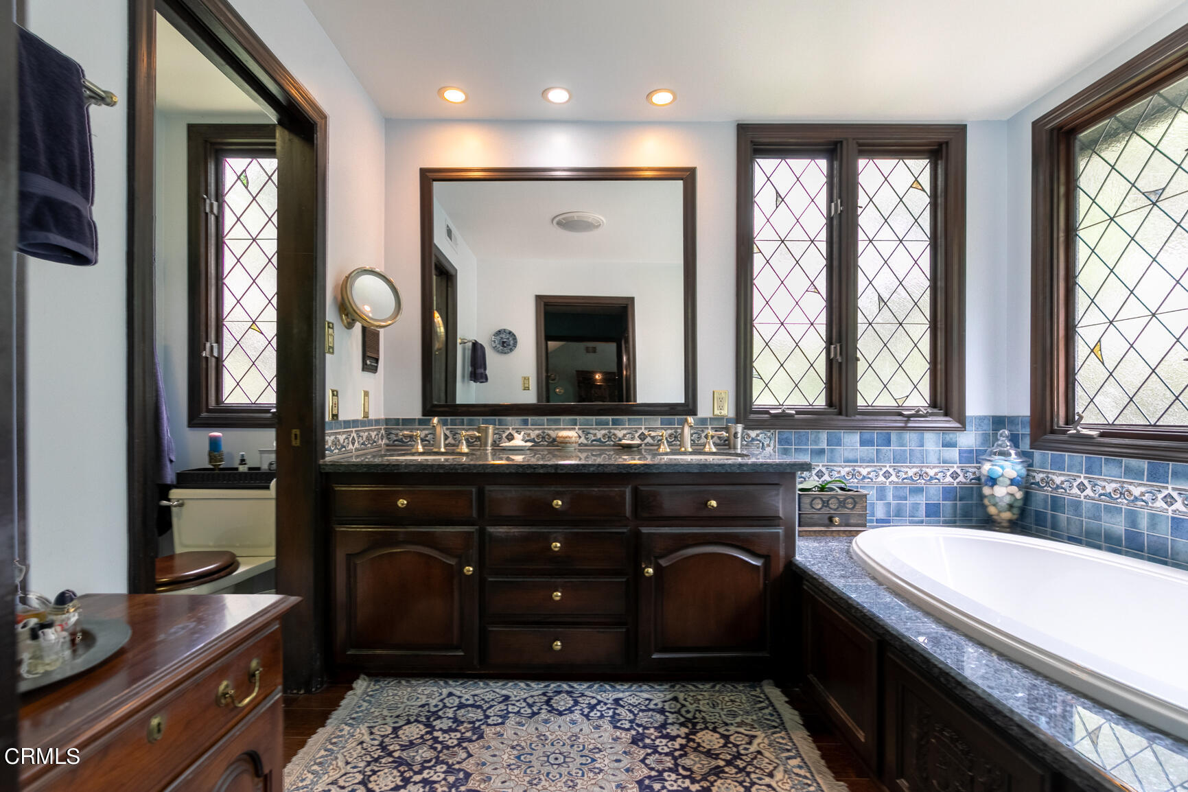 930 Ellington Lane Pasadena, CA 91105 - Photo 48 of 65 a bathroom with a granite countertop sink a large mirror and a window