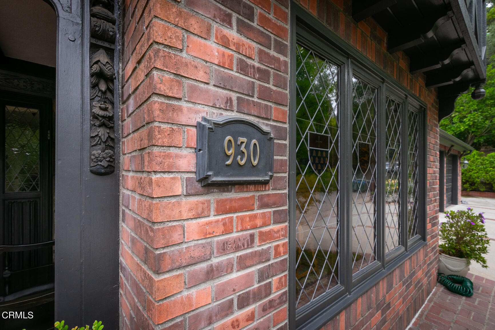 930 Ellington Lane Pasadena, CA 91105 - Photo 7 of 65 a view of a street with potted plants and brick walls of the building