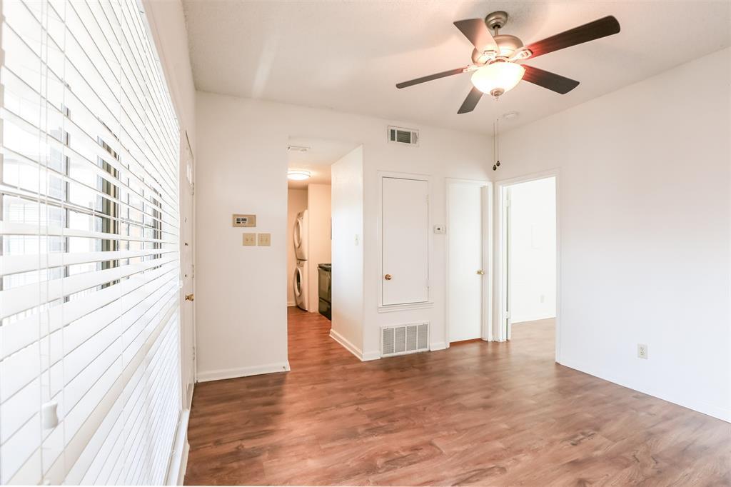 912 West 22nd Street, Unit 106 Austin, TX 78705 - Photo 2 of 11 a view of a big room with wooden floor and a chandelier fan