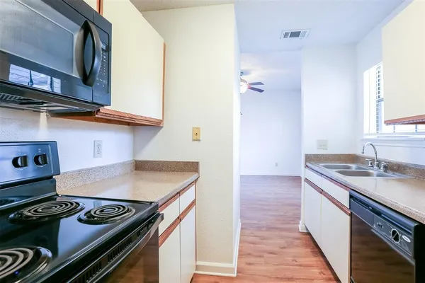 a kitchen with a stove and a sink