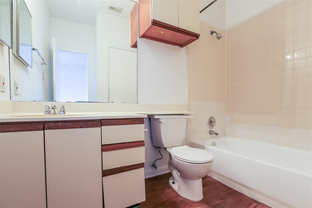 912 West 22nd Street, Unit 106 Austin, TX 78705 - Photo 6 of 11 a bathroom with a sink a toilet and a bathtub
