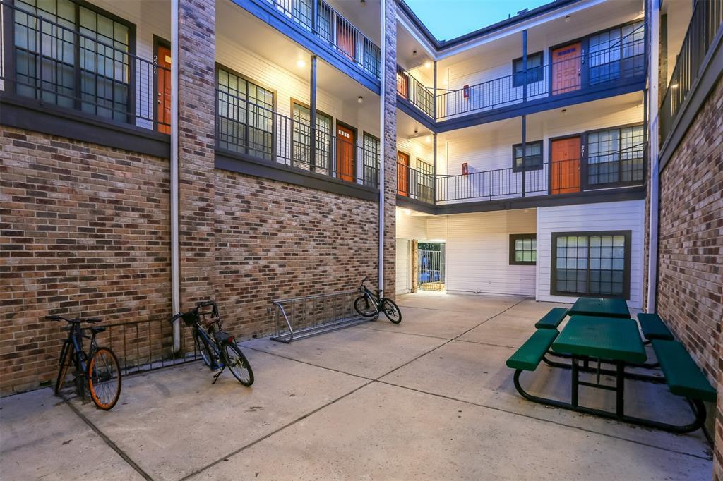 912 West 22nd Street, Unit 106 Austin, TX 78705 - Photo 7 of 11 a view of a brick building with a bench in front of building