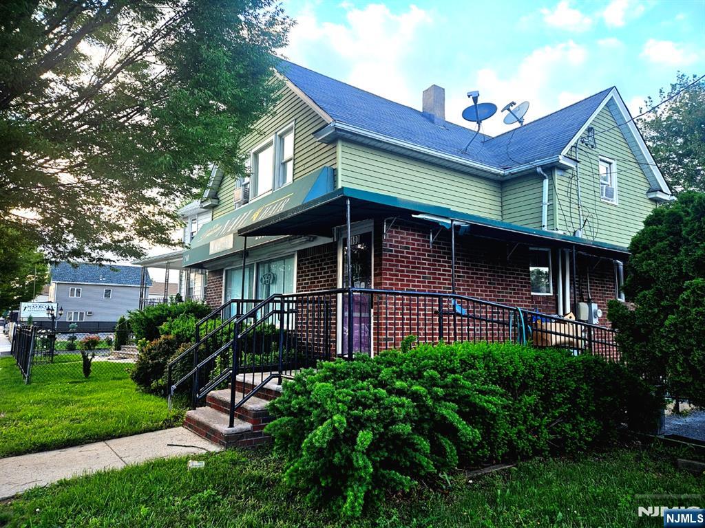 180 Main Street Little Ferry, NJ 07643 - Photo 1 of 8 a view of a house with brick walls and a table