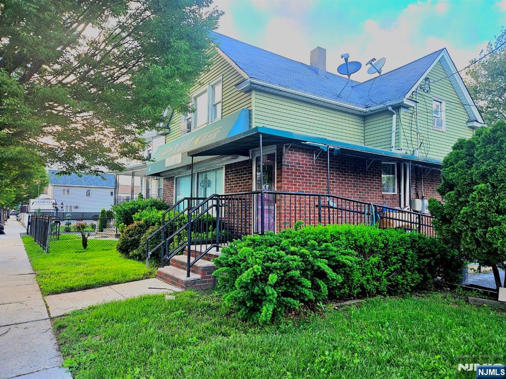 180 Main Street Little Ferry, NJ 07643 - Photo 3 of 8 a backyard of a house with plants and large tree