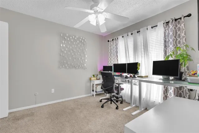 a view of a livingroom with workspace and a window