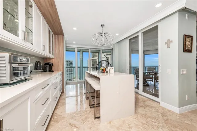 a large white kitchen with cabinets