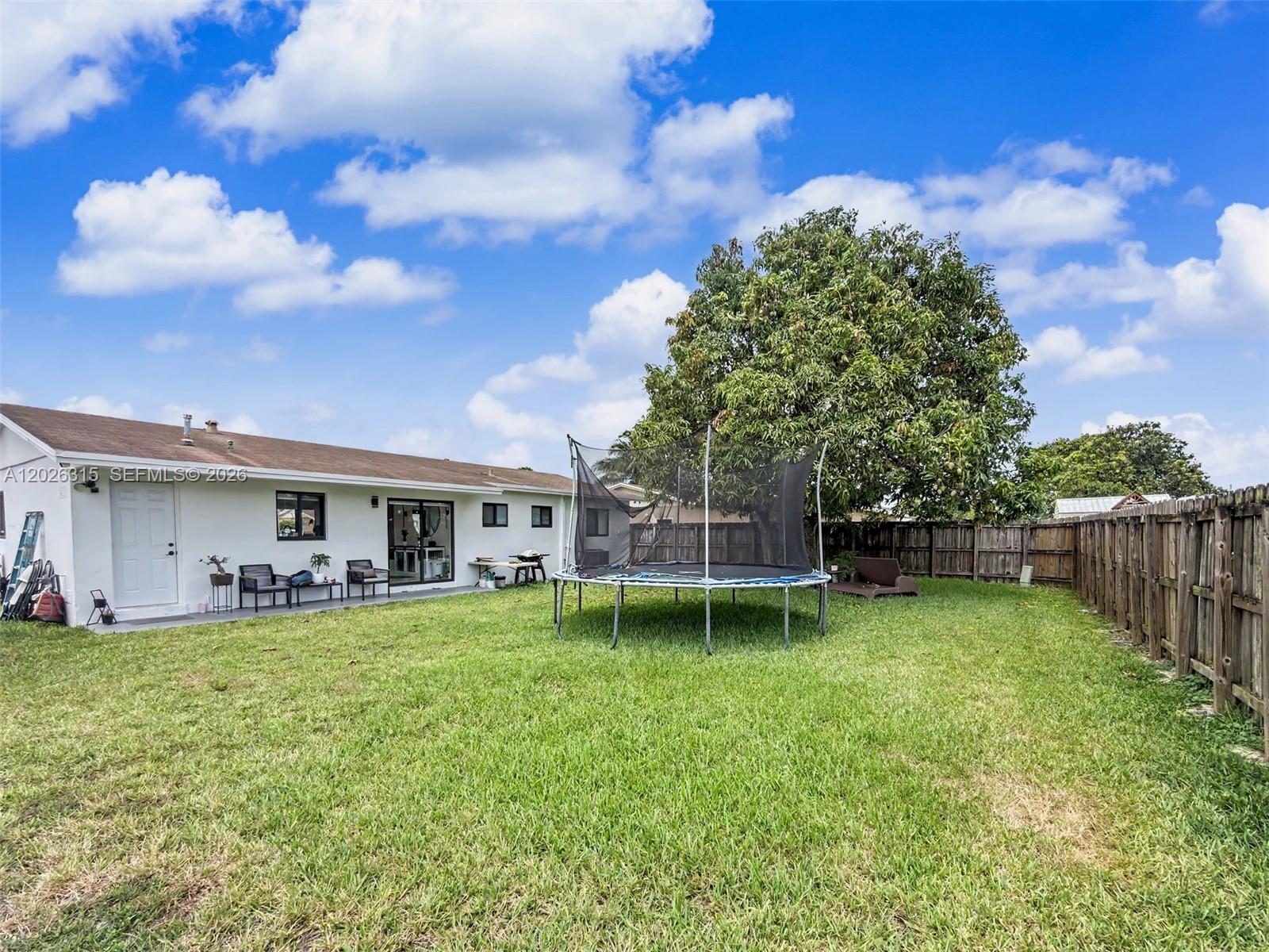 10762 Southwest 145th Street Miami, FL 33176 - Photo 25 of 28 a view of a house with a yard and sitting area