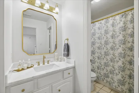a bathroom with a sink vanity and a mirror