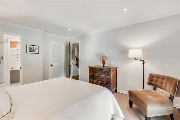 a bedroom with a large bed and a flat tv screen