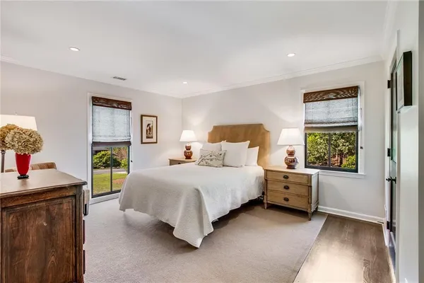 a spacious bedroom with a bed and a view of bathroom