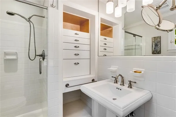 a bathroom with a shower and a glass door