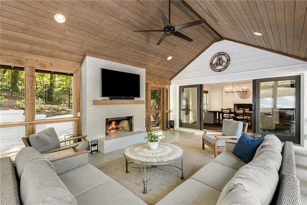 a view of a house with swimming pool and sitting area