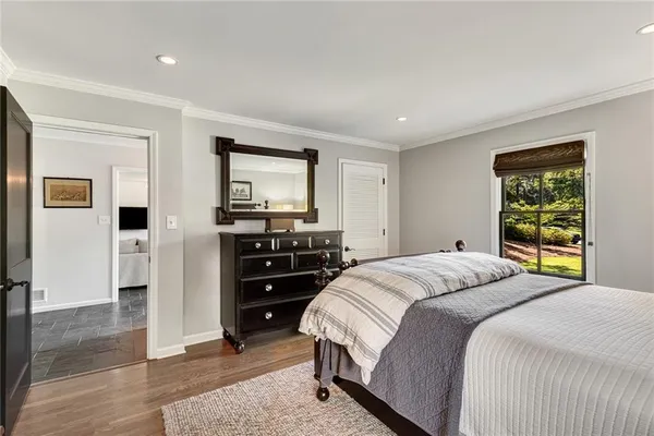 a kitchen with white cabinets and sink