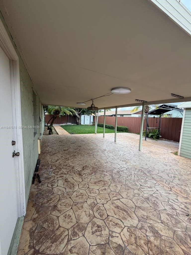 12241 Southwest 268th Street, Unit 1 Homestead, FL 33032 - Photo 14 of 25 a view of a patio with table and chairs a barbeque