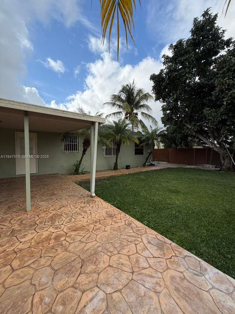 12241 Southwest 268th Street, Unit 1 Homestead, FL 33032 - Photo 15 of 25 a view of a house with a yard