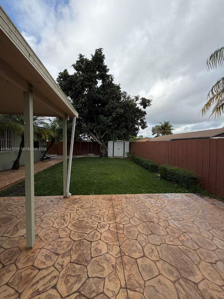 12241 Southwest 268th Street, Unit 1 Homestead, FL 33032 - Photo 17 of 25 a view of a patio with a yard