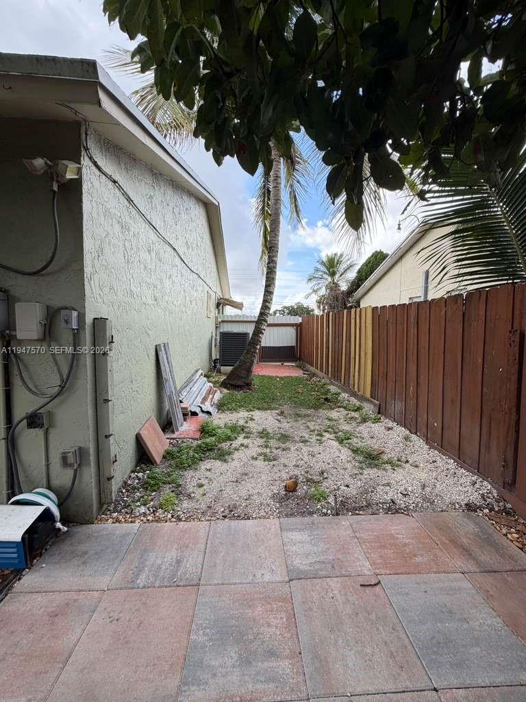 12241 Southwest 268th Street, Unit 1 Homestead, FL 33032 - Photo 20 of 25 a backyard of a house with lots of green space