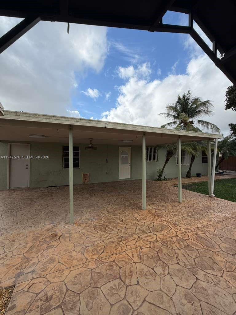 12241 Southwest 268th Street, Unit 1 Homestead, FL 33032 - Photo 23 of 25 a view of a house with a backyard of a house