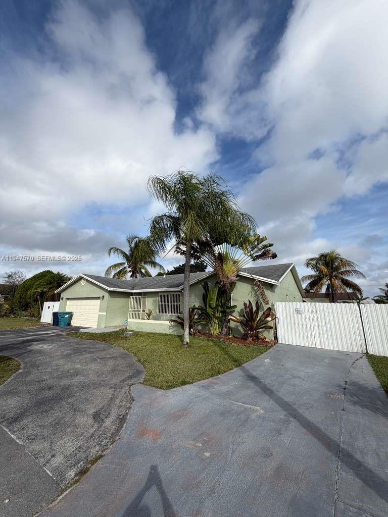 12241 Southwest 268th Street, Unit 1 Homestead, FL 33032 - Photo 3 of 25 a view of a street with cars on both side of the road