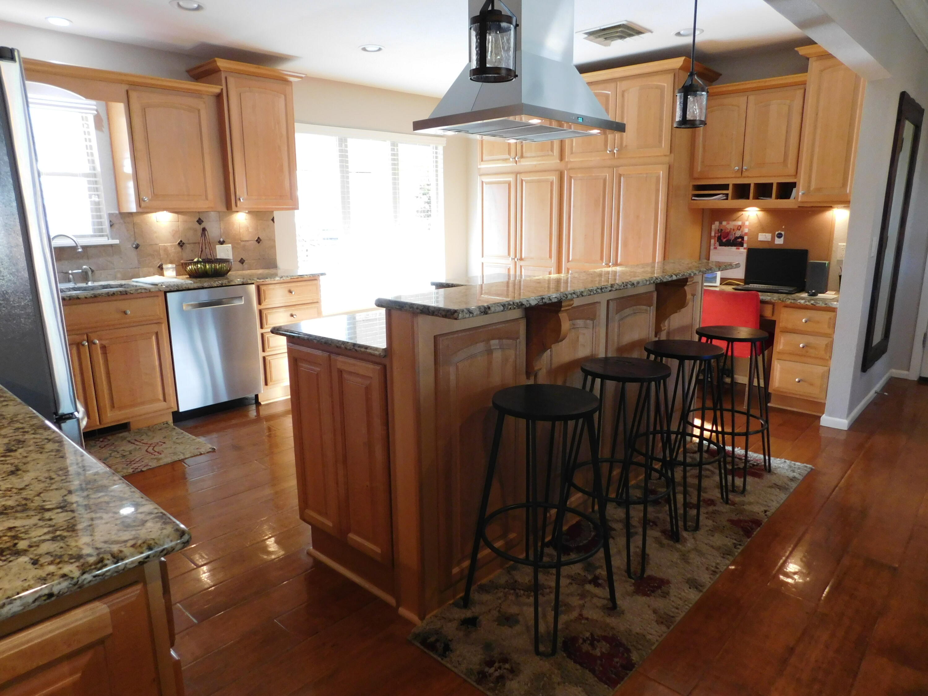 314 West Ave J Muleshoe, TX 79347 - Photo 13 of 40 a kitchen with granite countertop a stove a sink a dining table and chairs