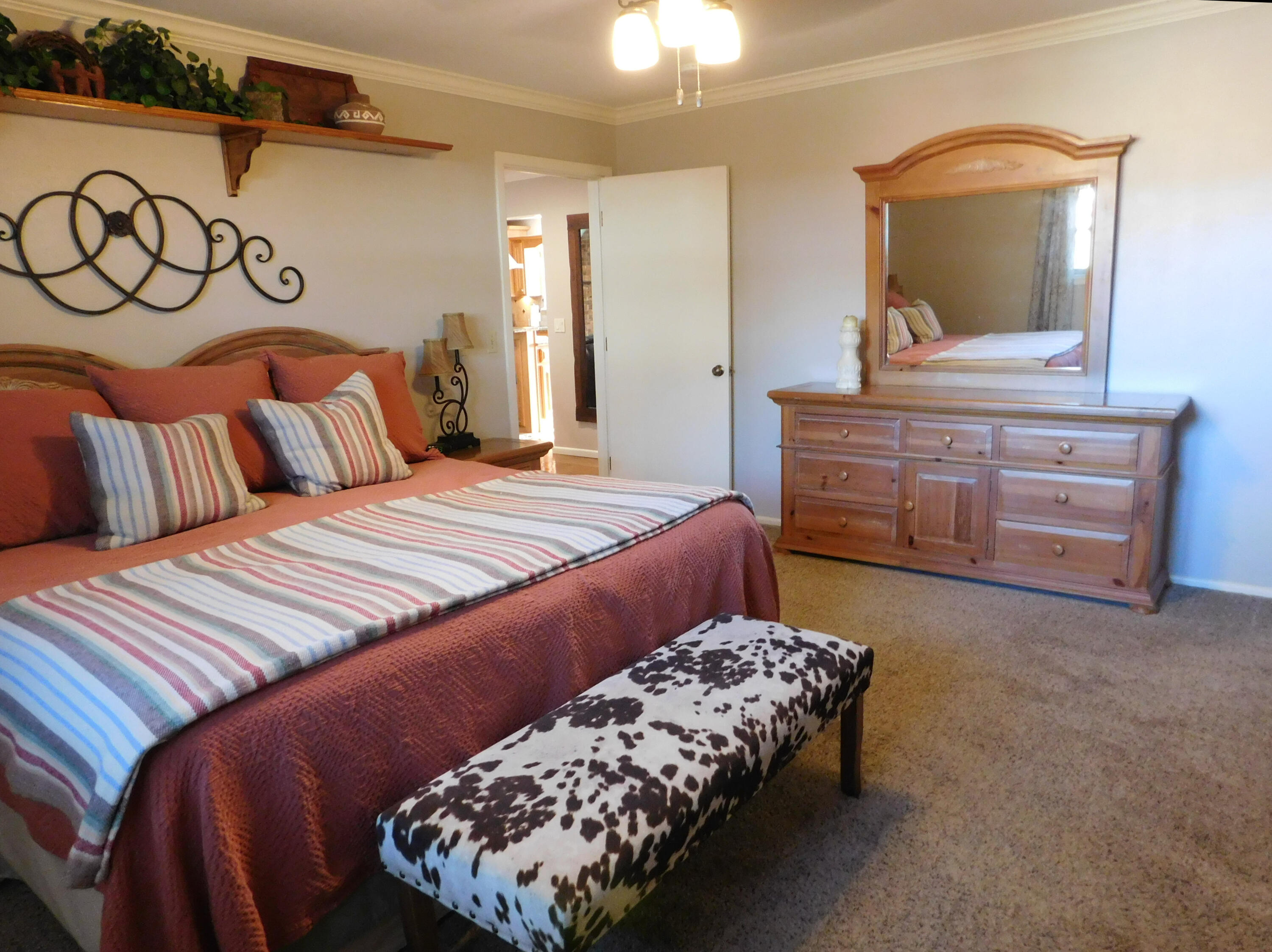314 West Ave J Muleshoe, TX 79347 - Photo 17 of 40 a bedroom with a bed and a dresser