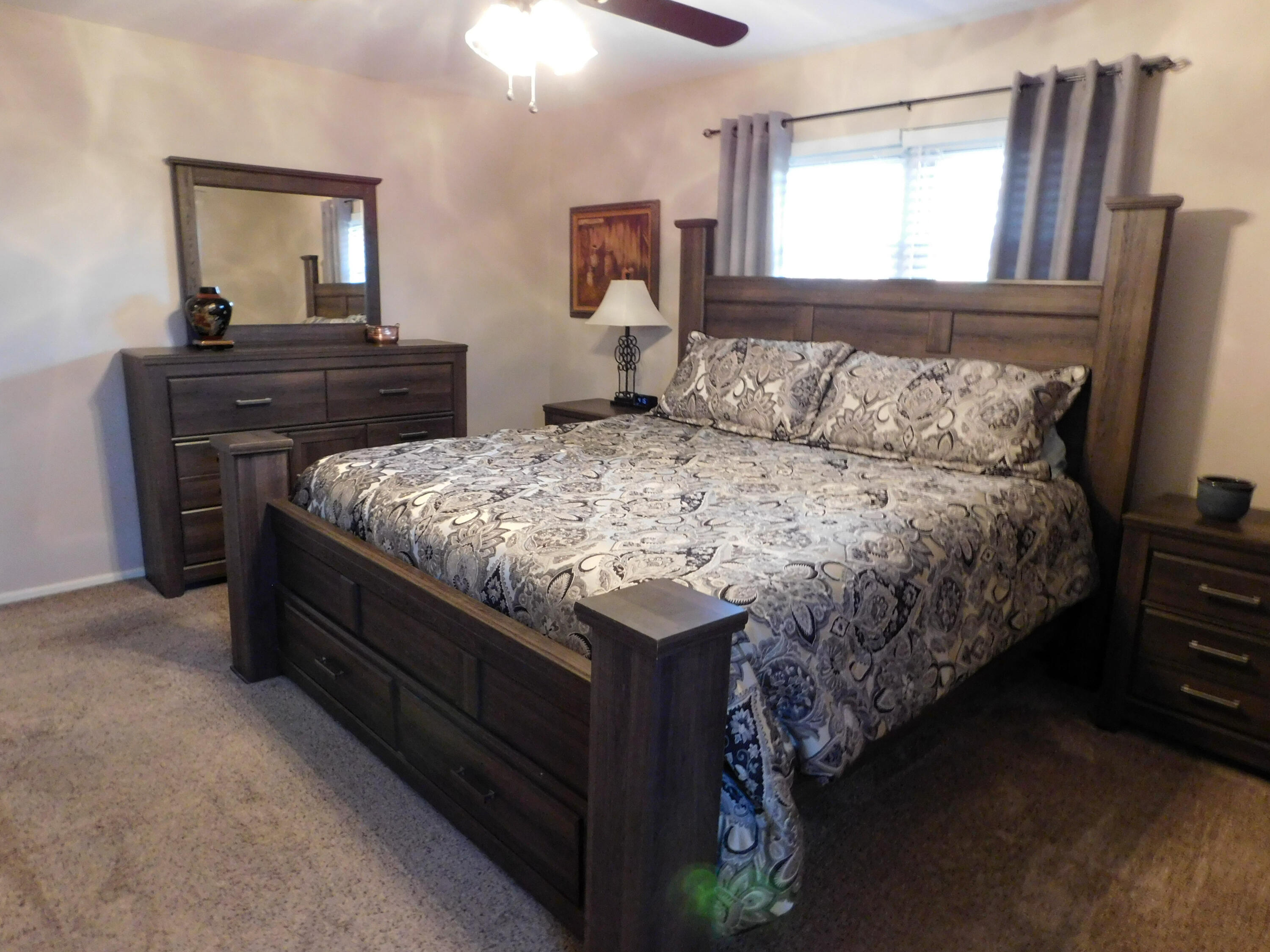 314 West Ave J Muleshoe, TX 79347 - Photo 29 of 40 a bedroom with a bed and dresser with mirror