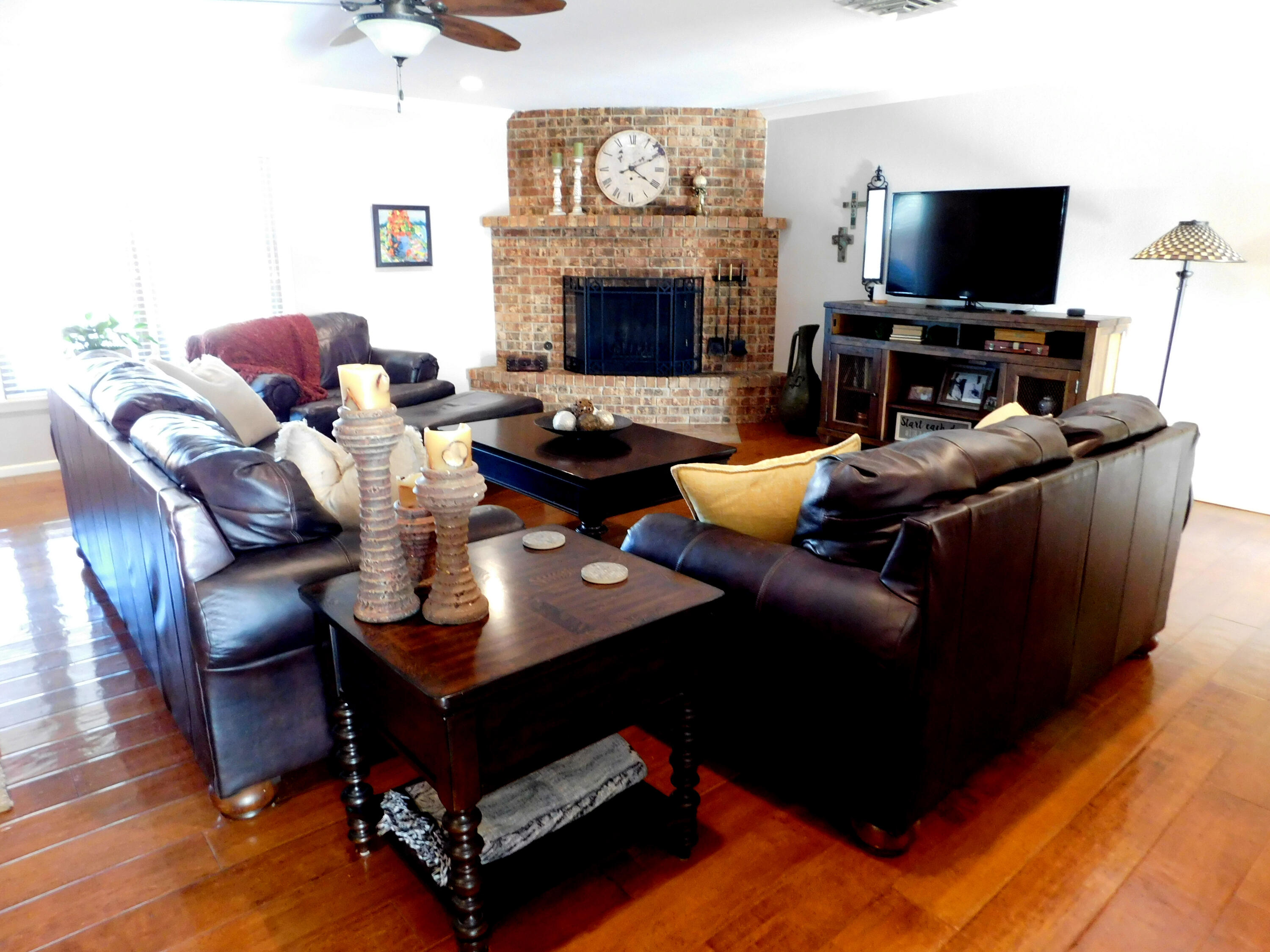 314 West Ave J Muleshoe, TX 79347 - Photo 5 of 40 a living room with furniture a flat screen tv and a fireplace