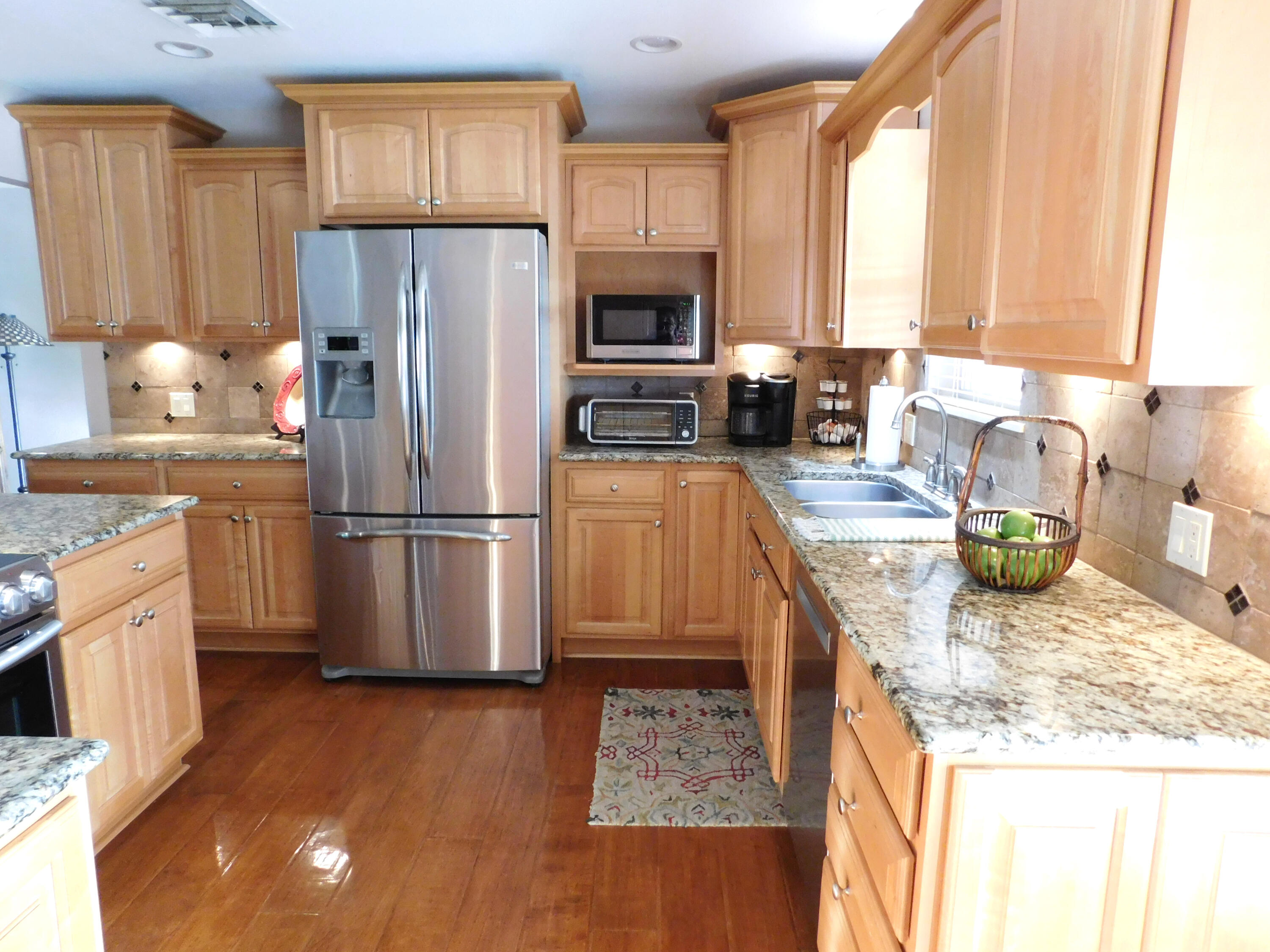 314 West Ave J Muleshoe, TX 79347 - Photo 9 of 40 a kitchen with refrigerator cabinets and wooden floor