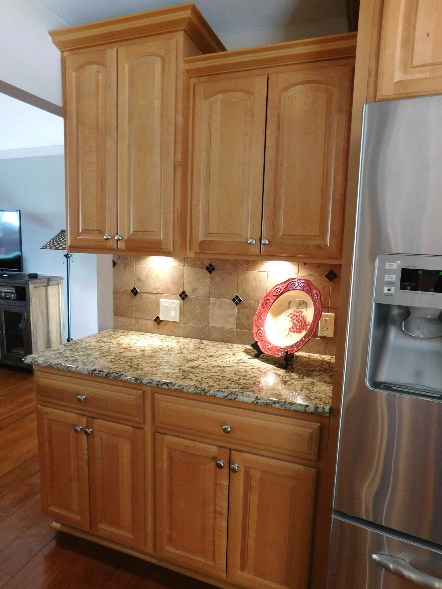 314 West Ave J Muleshoe, TX 79347 - Photo 10 of 40 a kitchen with granite countertop stainless steel appliances wooden floor and a refrigerator