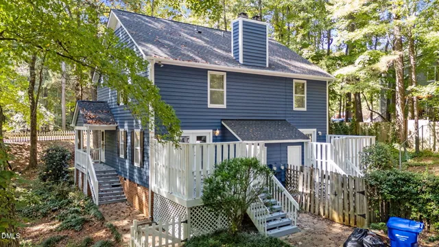 a front view of house with deck and yard