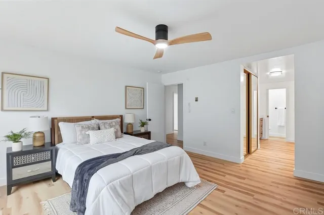 a bedroom with a bed and a potted plant