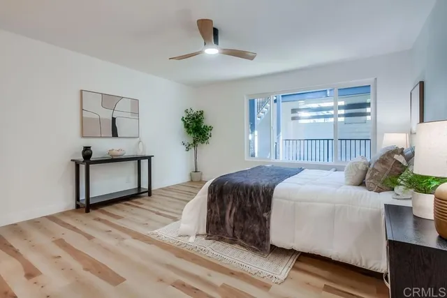 a bedroom with a large bed and a chandelier