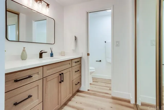 a en suite bathroom with a toilet a sink and a mirror