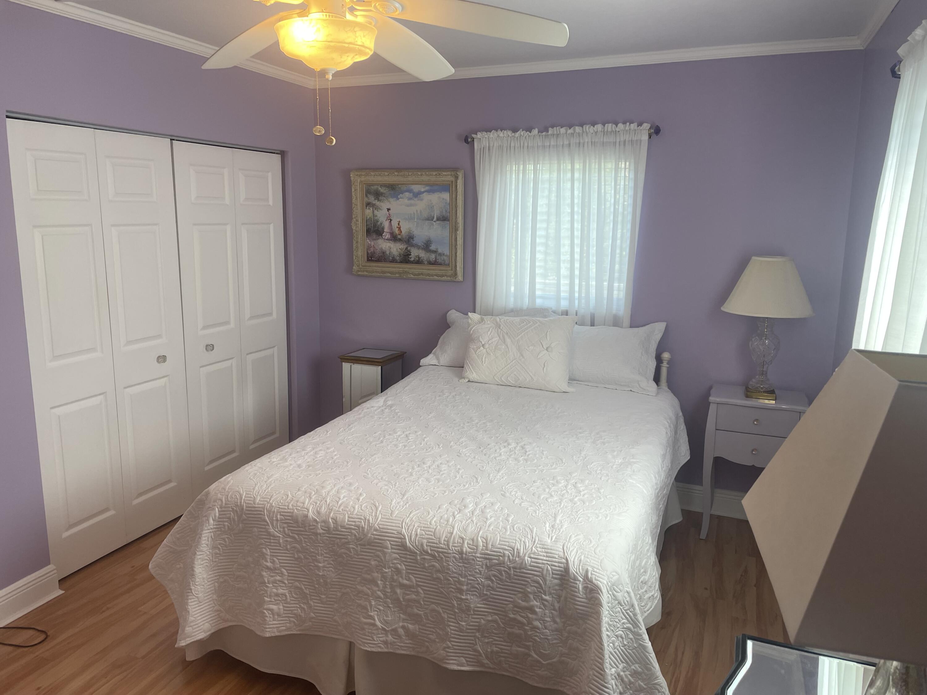 Undisclosed Address Big Pine Key, FL 33043 - Photo 16 of 28 a bedroom with a bed and a chandelier