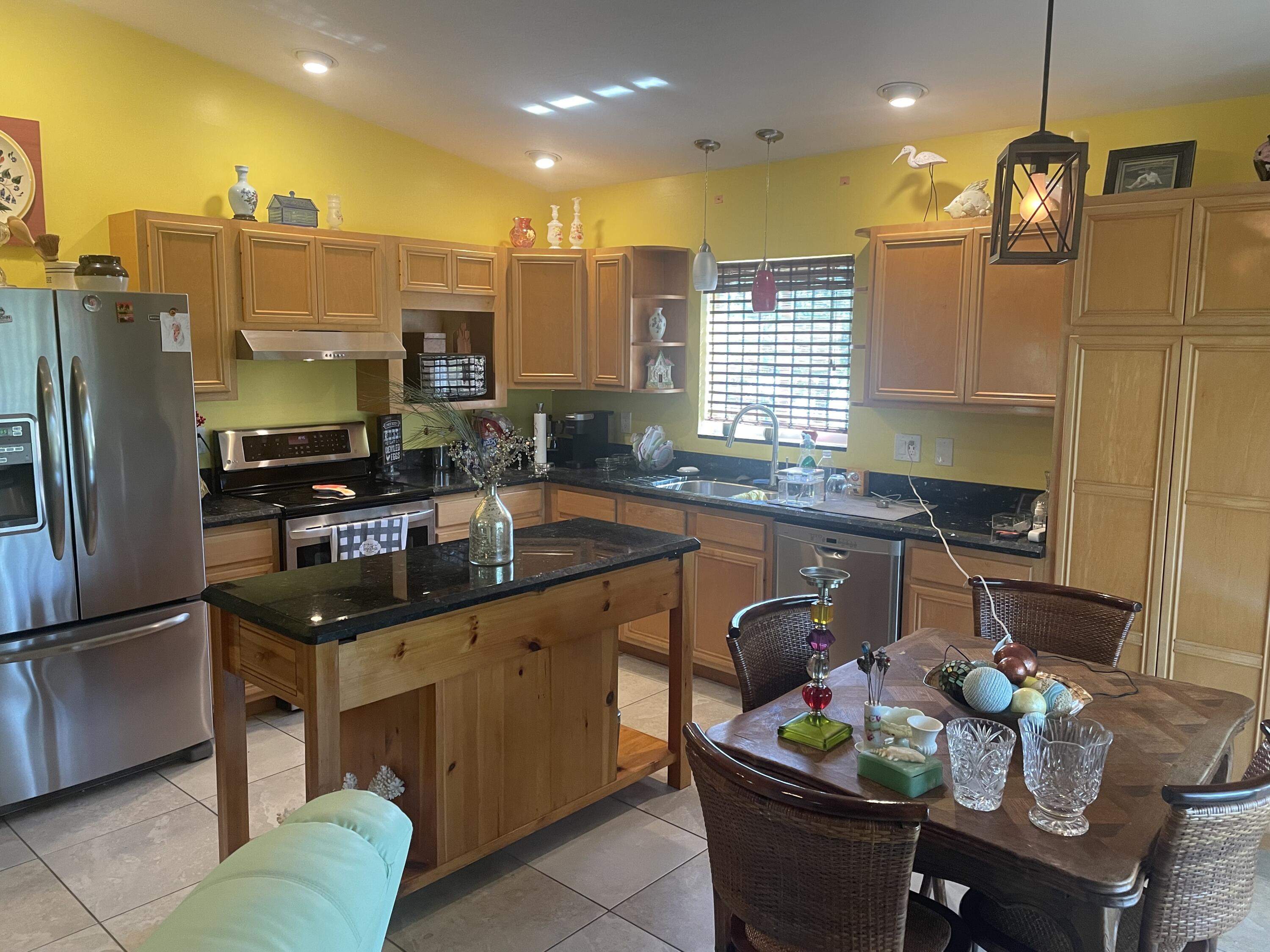 Undisclosed Address Big Pine Key, FL 33043 - Photo 2 of 28 a kitchen with stainless steel appliances granite countertop a sink a stove and a refrigerator