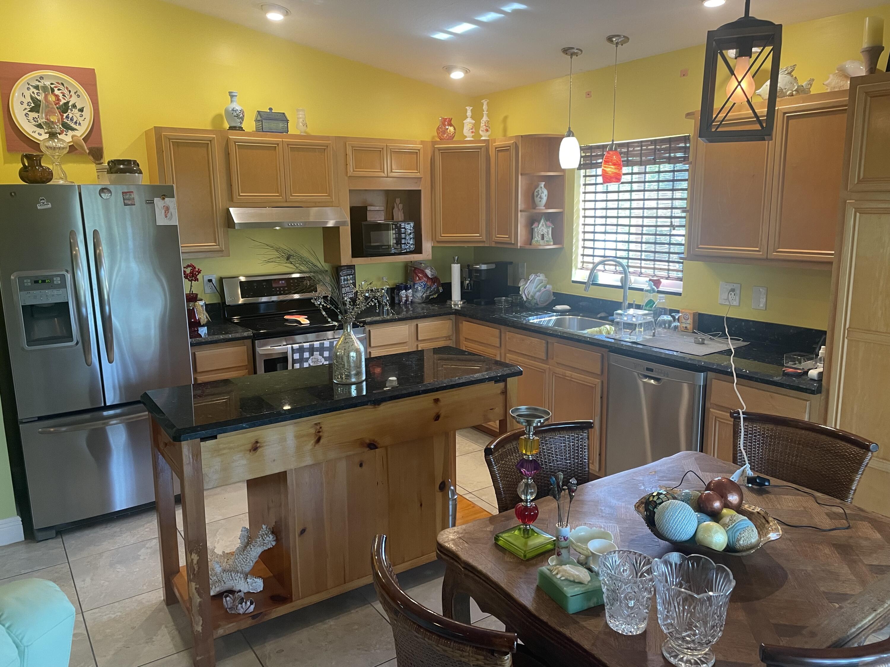 Undisclosed Address Big Pine Key, FL 33043 - Photo 4 of 28 a kitchen with stainless steel appliances granite countertop a sink refrigerator and cabinets