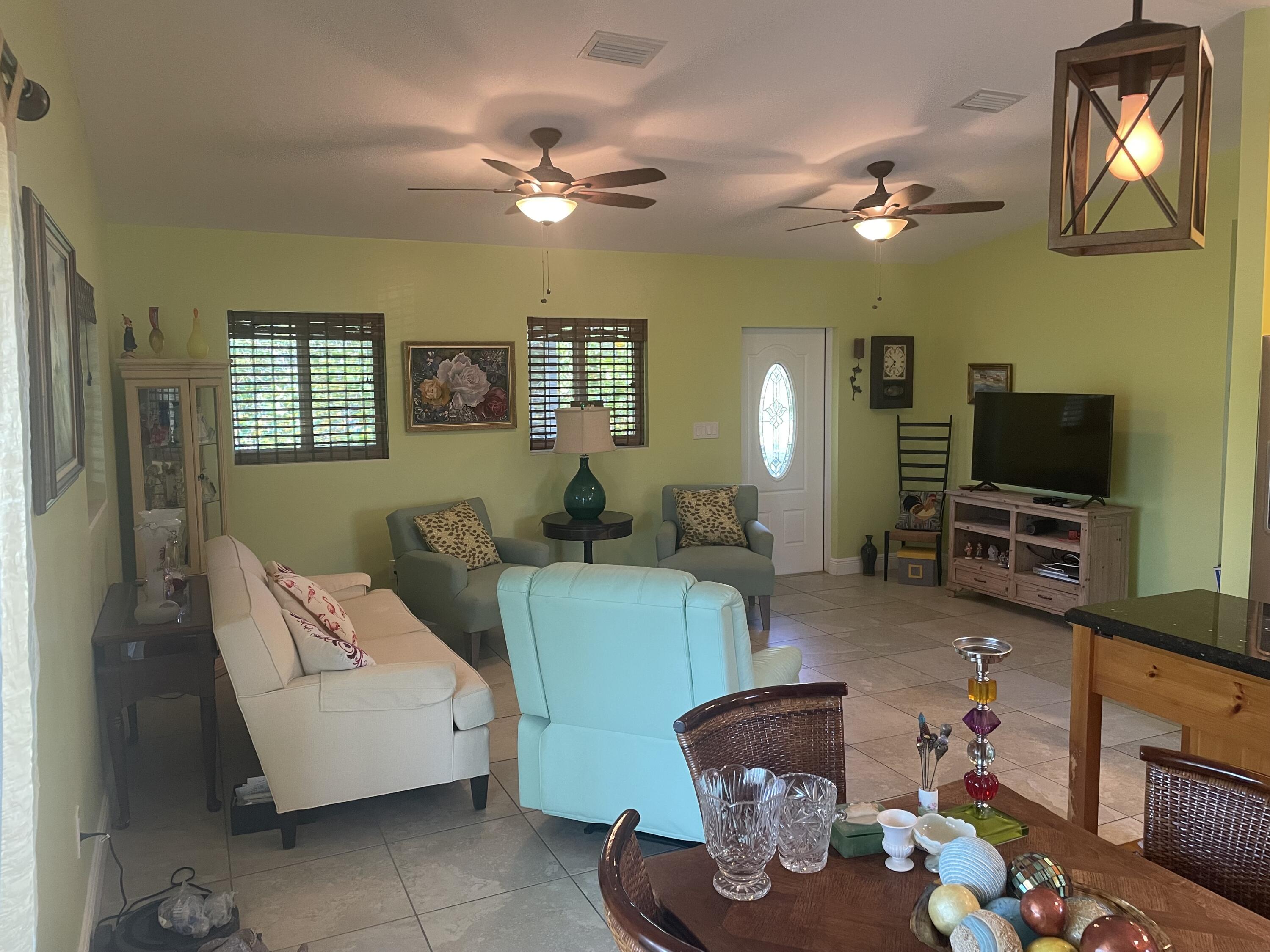Undisclosed Address Big Pine Key, FL 33043 - Photo 7 of 28 a living room with furniture and a flat screen tv