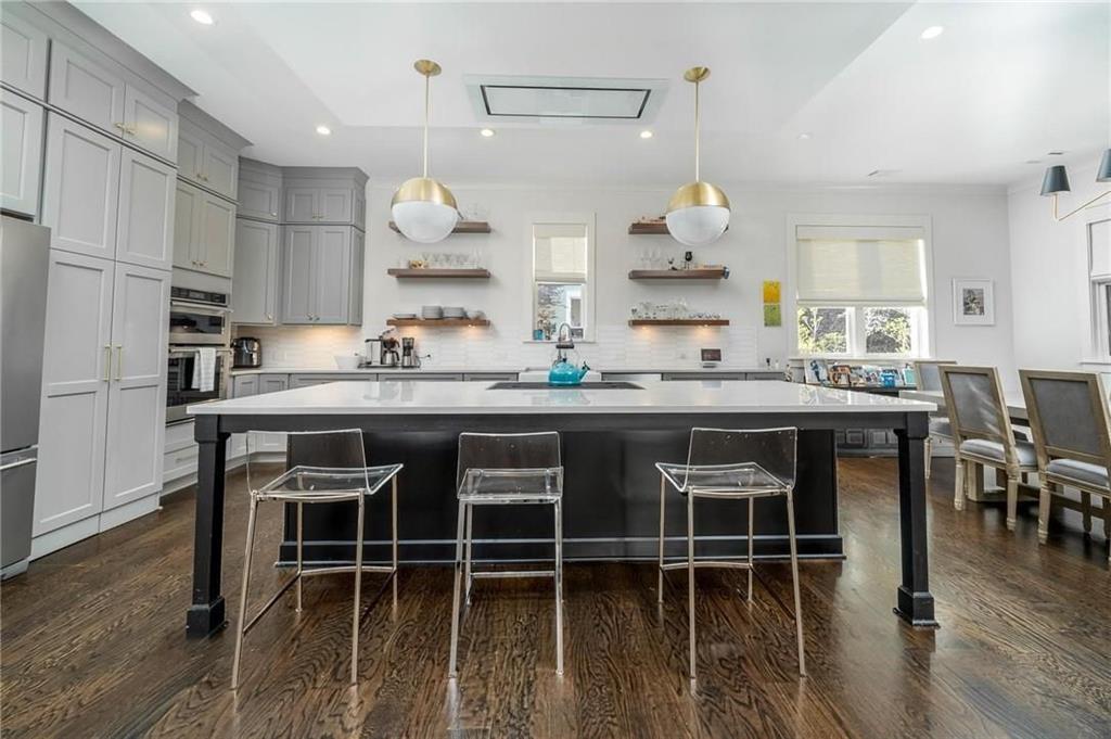 216 Haralson Lane Atlanta, GA 30307 - Photo 15 of 33 a kitchen with kitchen island granite countertop a table and chairs in it