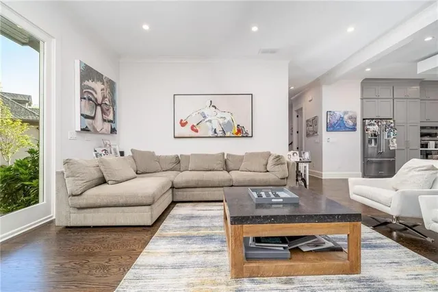 a living room with furniture a rug and a large window