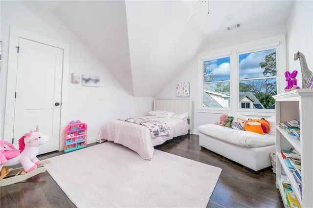 a bedroom with furniture and a potted plant